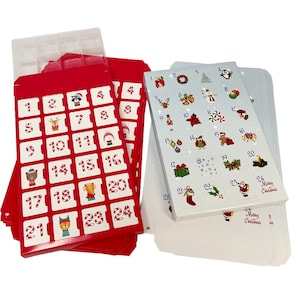 May include: A red Christmas advent calendar with 24 numbered compartments, each with a festive illustration. Includes a set of stickers with holiday-themed images. A clear plastic tray is visible at the top. The words "Merry Christmas" are printed on the stickers.