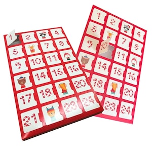 May include: Two red Christmas advent calendars with white squares numbered 1-24. Each square has a candy cane border and a festive illustration. One calendar's flap is open, revealing a silver interior.