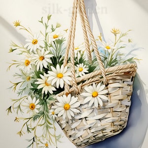 May include: A white wicker basket filled with white daisies and green foliage hangs from a thick rope. The basket is suspended against a white background.