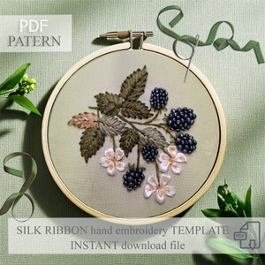 May include: A PDF pattern for a hand embroidery project featuring a sprig of blackberries with white flowers, stitched with silk ribbon. The pattern is shown in a wooden embroidery hoop on a green fabric background.