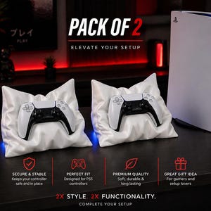 May include: Two white and black PS5 controllers rest on white satin pillows, with a PS5 console in the background. The text reads "PACK OF 2" and "ELEVATE YOUR SETUP". The image also includes text about the product's features.
