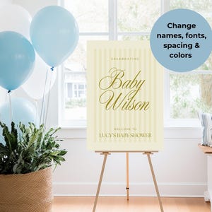 Elegant yellow stripe baby shower sign canva template, shown on a wooden easel surrounded by party decor — ideal for boy, girl, or gender-neutral showers.