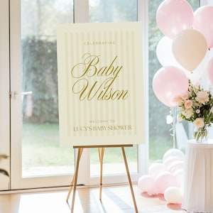A0 yellow striped baby shower welcome poster shown at a cheerful spring-themed celebration — digital download template editable in Canva for instant customization.