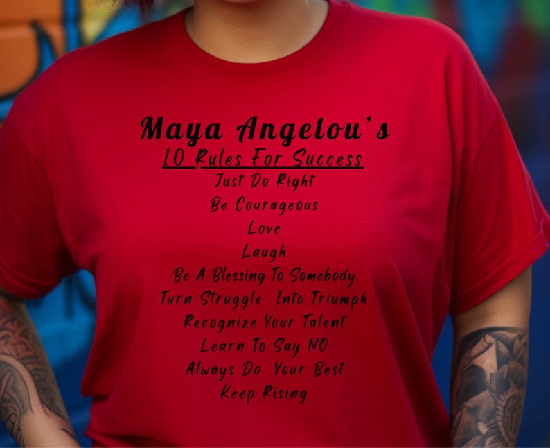 May include: Red t-shirt with black text that reads "Maya Angelou's 10 Rules For Success" and lists the rules: "Just Do Right", "Be Courageous", "Love", "Laugh", "Be A Blessing To Somebody", "Turn Struggle Into Triumph", "Recognize Your Talent", "Learn To Say NO", "Always Do Your Best", and "Keep Rising".
