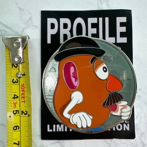 May include: A white ceramic mug with a black handle and the text "But First, Coffee" in a bold, black font. The mug is set against a neutral background, highlighting its simple design.