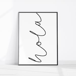 May include: A framed minimalist art print featuring the word "Mom" in a continuous black line against a white background. The artwork is encased in a black frame and stands on a white surface, creating a clean, modern aesthetic.