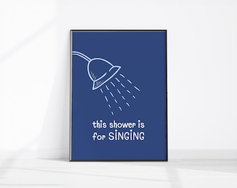 May include: Framed art print with a navy blue background. A white line drawing of a showerhead with water droplets is at the top. The text "this shower is for SINGING" is in white below the showerhead.
