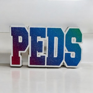 May include: A colorful sign with the word "PEDS" in large, white letters. Each letter is a different shade of blue, green, and red.
