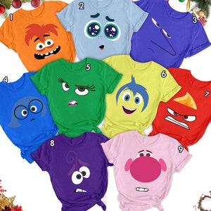 Peut inclure: Neuf t-shirts différents représentant des personnages du film d'animation Vice-Versa. Chaque t-shirt présente le visage d'un personnage différent, dont Joie, Tristesse, Colère, Peur, Dégoût, Bing Bong et le personnage du film 'Soul'.
