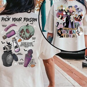 May include: Cream-colored t-shirt featuring a graphic design. The front design says "Villains Evil Tour" with cartoon images of Disney villains. The back design says "Pick Your Poison" with illustrations of poison bottles and a poison apple.
