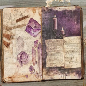 May include: Open book with aged pages, featuring illustrations of purple crystals and lit candles. The left page has sketches and crystals, while the right page shows candles and script. The book is open on a wooden surface.