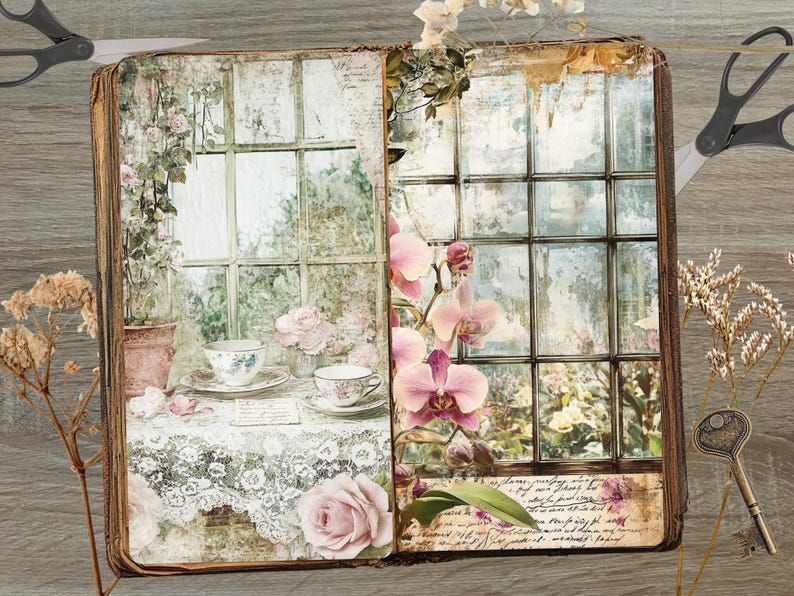 May include: A vintage-style journal with a floral and window design. The open pages display a tea setting and a window scene with pink orchids. The journal has a distressed, aged appearance, with scissors and a key on the wooden surface.