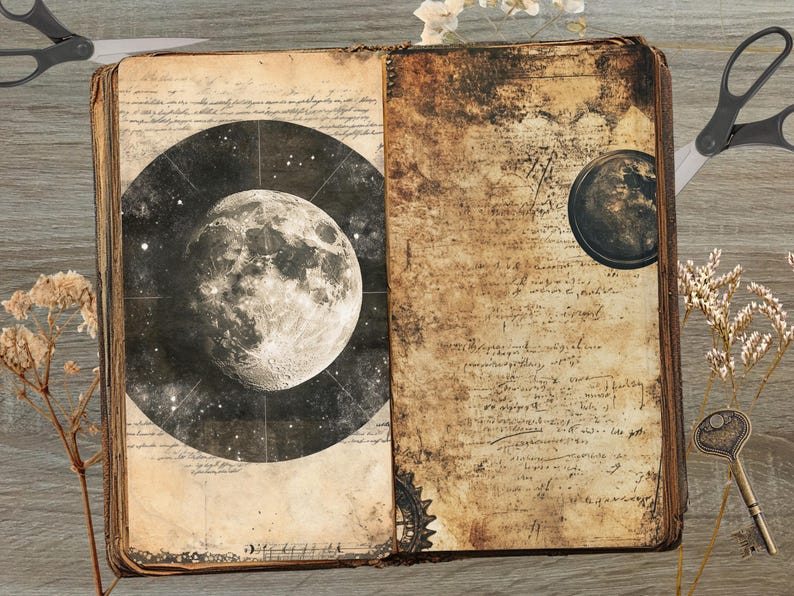 May include: An open, antique-style book with aged, textured pages. One page features a detailed illustration of the moon against a starry background. The other page has handwritten script. Decorative elements include scissors, a key, and dried flowers.