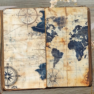 May include: An open vintage journal with a world map printed on the pages. The map is in shades of blue and white, with a compass rose at the bottom of each page. The journal has a worn, aged look, with brown leather binding.