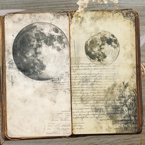 May include: Open vintage book with two moon illustrations. The left page features a large, detailed grayscale moon, while the right page shows a smaller moon. The pages have aged paper with handwritten script and botanical elements. Scissors and a key are also visible.