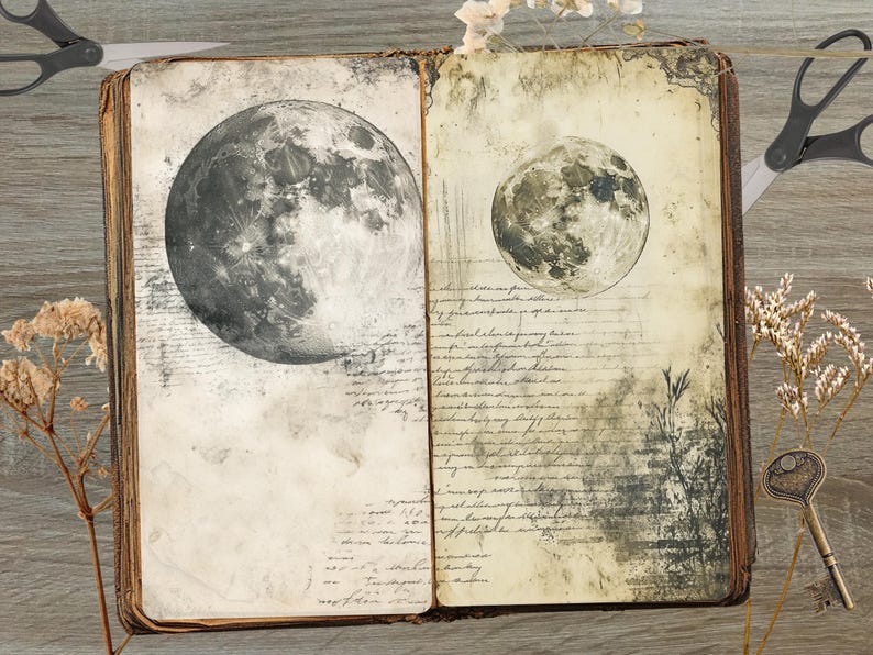 May include: Open vintage book with two moon illustrations. The left page features a large, detailed grayscale moon, while the right page shows a smaller moon. The pages have aged paper with handwritten script and botanical elements. Scissors and a key are also visible.