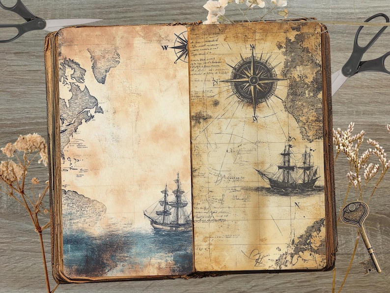 May include: An open antique book with a vintage map and compass design. The book is open to a page with a map of North America and a compass rose. The book is surrounded by dried flowers and scissors.