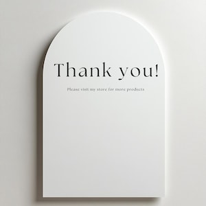 May include: A white, arched sign with the words "Thank you!" in black script. Below, smaller text reads "Please visit my store for more products". The sign is set against a plain white background.