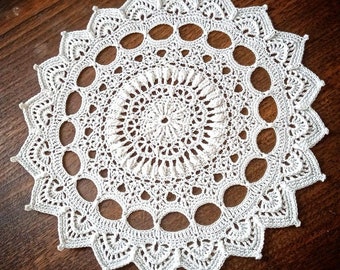 White doily with embossed motifs