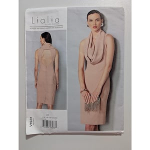 May include: A sewing pattern for a sleeveless dress with a cowl neck. The pattern is for sizes 12-14-16-18-20 and is from the Lialia by Julia Alarcon Vogue Patterns American Designer collection. The pattern number is V1531.