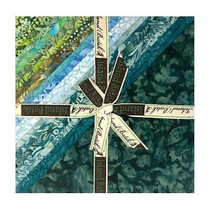 May include: A bundle of 10 fat quarters of fabric in shades of blue and green with a batik pattern. The fabric is tied with brown ribbon with the text "Island Batik" printed on it.