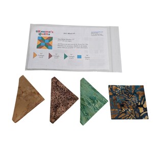May include: A quilting kit with a printed diagram and fabric pieces. The kit includes a diagram from "Keama's Quilts" and several fabric triangles and a square in shades of brown, green, and blue. The diagram reads "2013 Block #5".