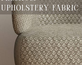 May include: An armchair upholstered in a taupe fabric with a repeating white floral pattern. The chair features light wooden legs and the text PREMIUM UPHOLSTERY FABRIC and APOSTROFO DESIGN are visible on the image.