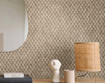 May include: Wallpaper featuring a repeating pattern of small white floral motifs on a textured brown background. The design includes a light wood surface with a black book, a white abstract sculpture, a ribbed cup, and a woven lamp. Text reads APOSTROFO DESIGN.