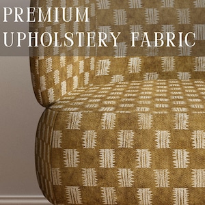 May include: A chair upholstered in mustard yellow fabric with a repeating white geometric pattern. The text PREMIUM UPHOLSTERY FABRIC is overlaid in white, and APOSTROFO DESIGN is printed at the bottom. The chair has light brown wooden legs.