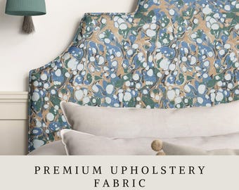 May include: A curved headboard upholstered in fabric with a marbled pattern of blue, green, and tan swirls. A wall-mounted lamp with a teal shade hangs to the left. The text reads PREMIUM UPHOLSTERY FABRIC APOSTROFO DESIGN.