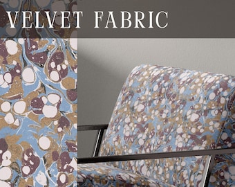May include: Upholstery velvet fabric featuring a marbled pattern in shades of light blue, dark maroon, white, and gold. The fabric is displayed on an armchair with a black metal frame. The text UPHOLSTERY VELVET FABRIC and APOSTROFO DESIGN are visible.