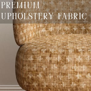 May include: A chair upholstered in a textured golden-brown fabric with a repeating white cross-stitch pattern. The text PREMIUM UPHOLSTERY FABRIC is overlaid at the top, and APOSTROFO DESIGN is printed at the bottom of the image.
