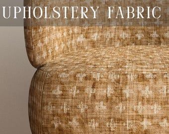 May include: A chair upholstered in a textured golden-brown fabric with a repeating white cross-stitch pattern. The text PREMIUM UPHOLSTERY FABRIC is overlaid at the top, and APOSTROFO DESIGN is printed at the bottom of the image.