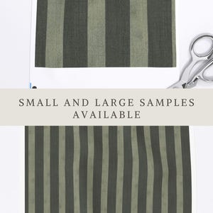 May include: Fabric swatch featuring vertical stripes in alternating shades of dark charcoal and muted sage green. The text APOSTROFO DESIGN appears at the top, and the text SMALL AND LARGE SAMPLES AVAILABLE is centered across the middle. Silver scissors.