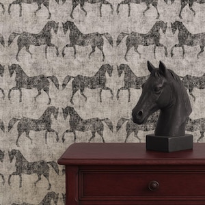 May include: A dark red wooden side table with a drawer, a black horse head sculpture, and a wallpaper background featuring a repeating pattern of black horses. The text "APOSTROFO DESIGN" is visible at the bottom.