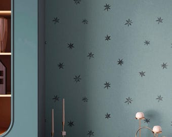 May include: A teal wall featuring a repeating pattern of dark gray eight-pointed stars. The wall is positioned behind a dark teal console table with a fluted front, featuring the text APOSTROFO DESIGN printed in white at the bottom center.