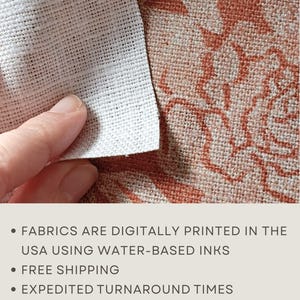 May include: A piece of white fabric with a visible grid-like weave texture is held over a larger piece of fabric featuring a terracotta-coloured floral pattern. The text on the image reads: FABRICS ARE DIGITALLY PRINTED IN THE USA USING WATER-BASED INKS.