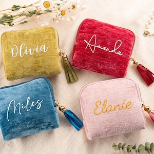 May include: Four square velvet zippered pouches in mustard yellow, red, blue, and light pink. Each pouch features a gold-tone zip with a matching tassel and a personalised name in script font: Olivia, Amanda, Miles, and Elanie.