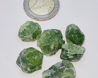 Olivine. Peridot. Unprocessed green peridot, for handicrafts and jewelry work. Decorative or gemstone.