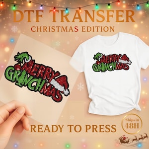 May include: A white t-shirt with a "Merry Grinchmas" design, alongside a ready-to-press transfer of the same design. The text "DTF TRANSFER CHRISTMAS EDITION" is at the top. The image also includes the text "READY TO PRESS".