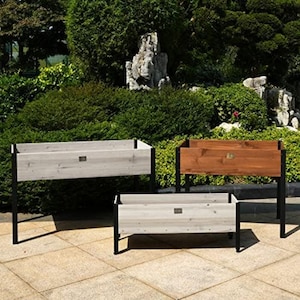 May include: Three raised garden beds, two are white wood and one is brown wood. All three have black metal legs.
