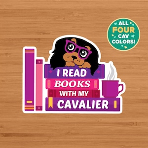 May include: A sticker featuring a Cavalier King Charles Spaniel wearing glasses, atop a stack of books. The books are purple and pink, with the text "I READ BOOKS WITH MY CAVALIER." A mug of coffee sits beside the books. A green circle reads "ALL FOUR CAV COLORS!"