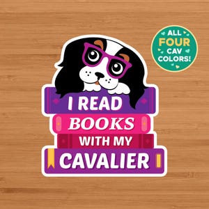 May include: A sticker featuring a Cavalier King Charles Spaniel wearing pink glasses, atop a stack of purple books. The text reads "I READ BOOKS WITH MY CAVALIER." A green circle states "ALL FOUR CAV COLORS!"