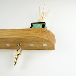 Minimalistic key holder with hidden magnets, solid oak entry way key holder for modern hallways decorate and organized mudroom spaces.