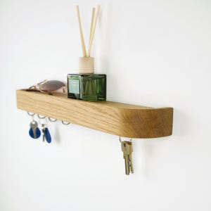 Op de afbeelding: Een set van drie keramische mokken met een gespikkelde, matte afwerking. De mokken zijn in de tinten crème, lichtgrijs en donkergrijs. Elke mok heeft een eenvoudig, minimalistisch ontwerp en een afgeronde handgreep. Geschikt voor koffie, thee of andere dranken.