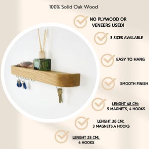 May include: A solid oak wood wall shelf featuring metal hooks for keys, with text listing features: 100% Solid Oak Wood, No Plywood Or Veneers Used, 3 Sizes Available, Easy To Hang, Smooth Finish, and specific dimensions for 48 cm, 38 cm, and 28 cm.