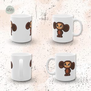 May include: Four white ceramic mugs with a cartoon image of a brown bear with big ears. The bear is wearing a blue shirt and has a brown hat. The mugs are all the same size and shape.