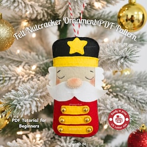 May include: A felt nutcracker ornament with a red body, yellow accents, and a black hat with a yellow star. The ornament has a white beard and a pink nose. Text on the image reads "Felt Nutcracker Ornament PDF Pattern" and "PDF Tutorial for Beginners".