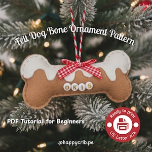 May include: A felt dog bone ornament with the text "OKOS" in the center. The bone is brown with white frosting-like accents and a red and white checkered bow. The ornament hangs from a red and white string. Text on the image reads "Felt Dog Bone Ornament Pattern".