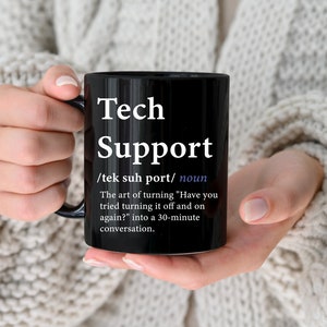 Könnte beinhalten: Schwarze Kaffeetasse mit weißem Text, der lautet: "Tech Support /tek suh port/ Substantiv Die Kunst, "Haben Sie versucht, es aus- und wieder einzuschalten?" in ein 30-minütiges Gespräch zu verwandeln."